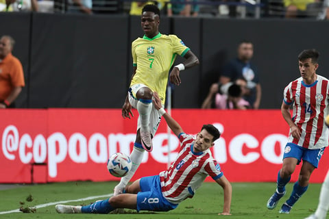 Vinicius Junior is tackled by Damian Bobadilla